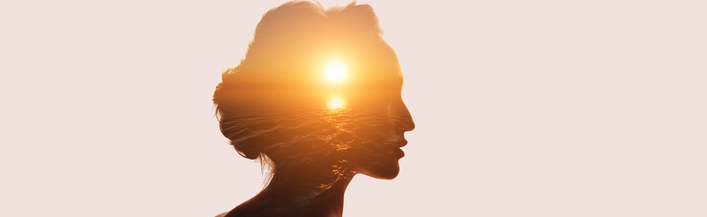 Silhouette of women with sunset in background